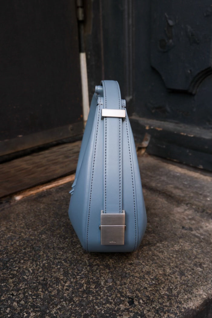 Osoi crescent shaped Toni mini bag smooth mid blue grey leather | Pipe and Row