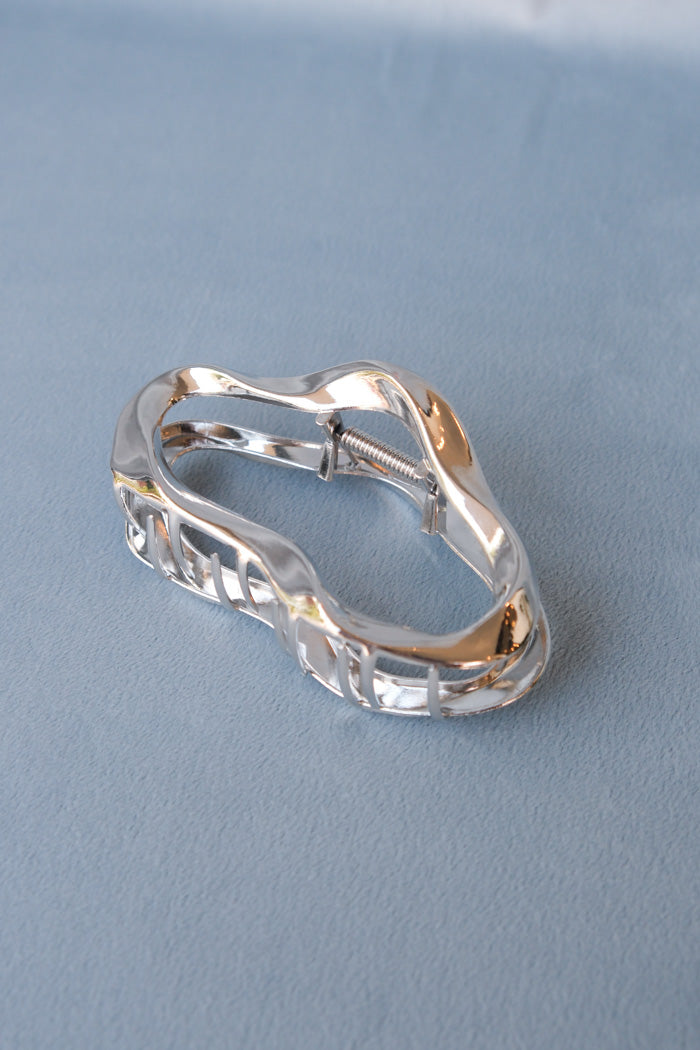 Large metal open oval hair claw in silver. PIPE AND ROW