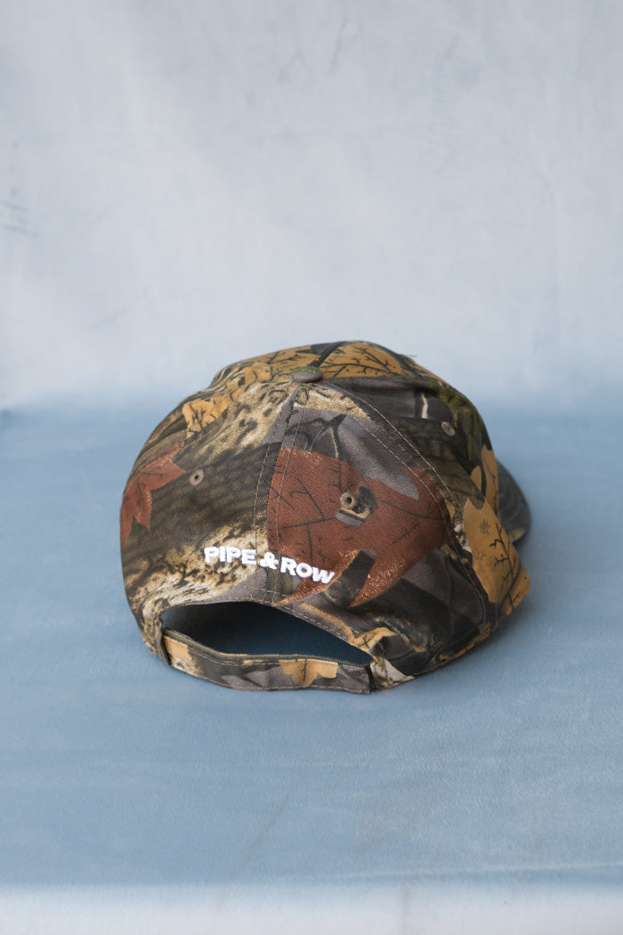 Pipe and Row camo hat embroidered white flower "P&R" back | PIPE AND ROW