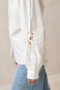 Alohas white button up Sugar shirt eyelet bow details on arms, and tie at back waist PIPE AND ROW