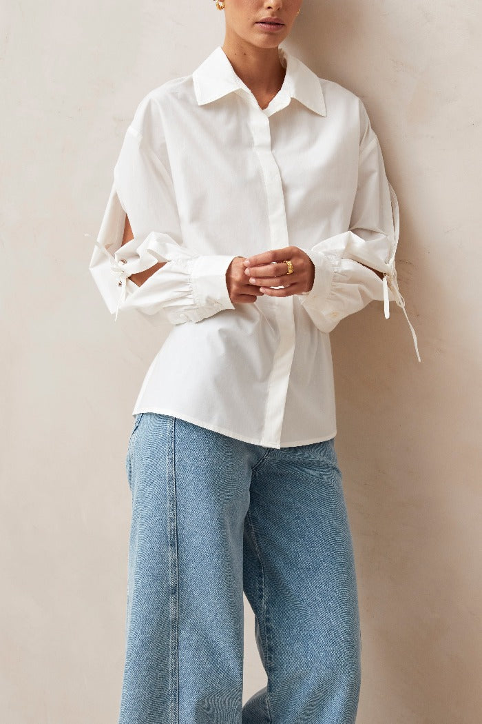 Alohas white button up Sugar shirt eyelet bow details on arms, and tie at back waist PIPE AND ROW