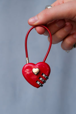 Red heart lock bag charm with silver hardware. PIPE AND ROW
