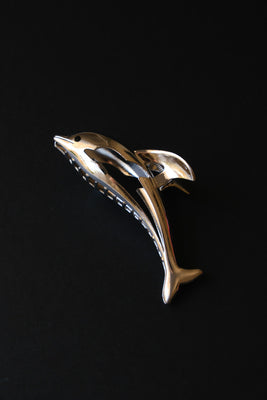 Silver metal dolphin hair claw. PIPE AND ROW